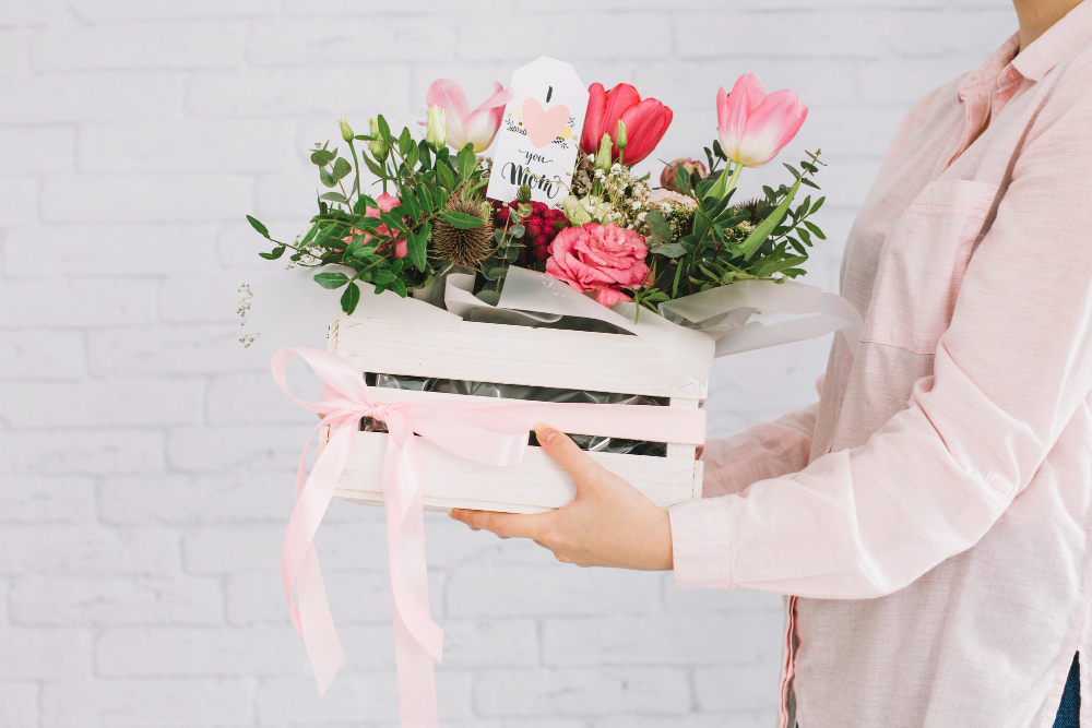 mothers-day-background-with-woman-holding-flower-box